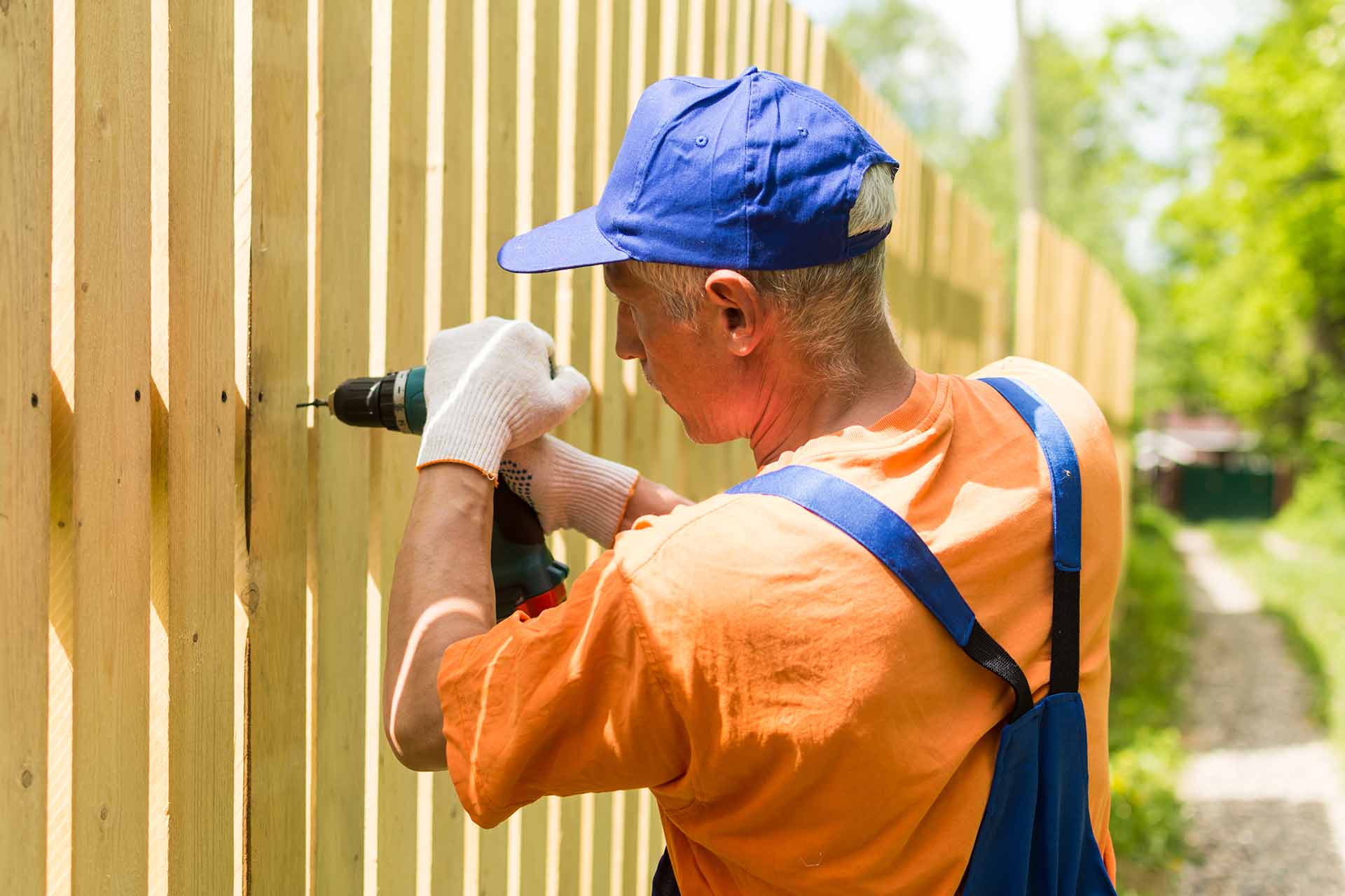 Skilled fence installers working on a residential backyard project