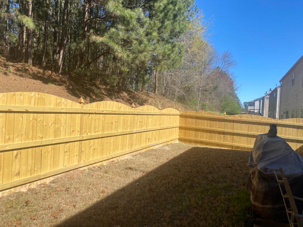 Skilled fence installers working on a residential backyard project