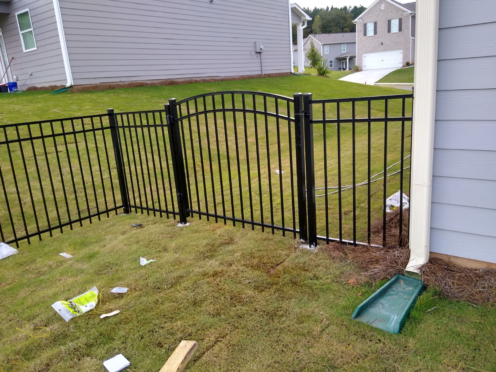 Decorative aluminum fence surrounding a front yard