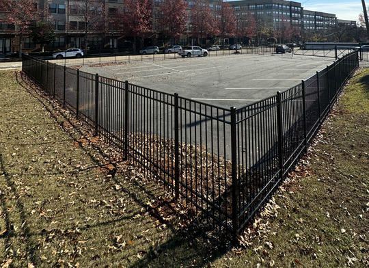 Commercial chain link fence installation at a Raleigh business property