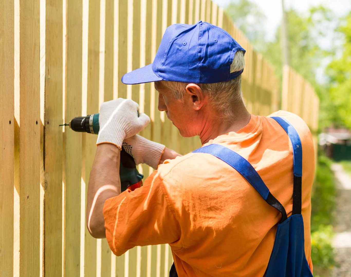 Skilled fence installers working on a residential backyard project