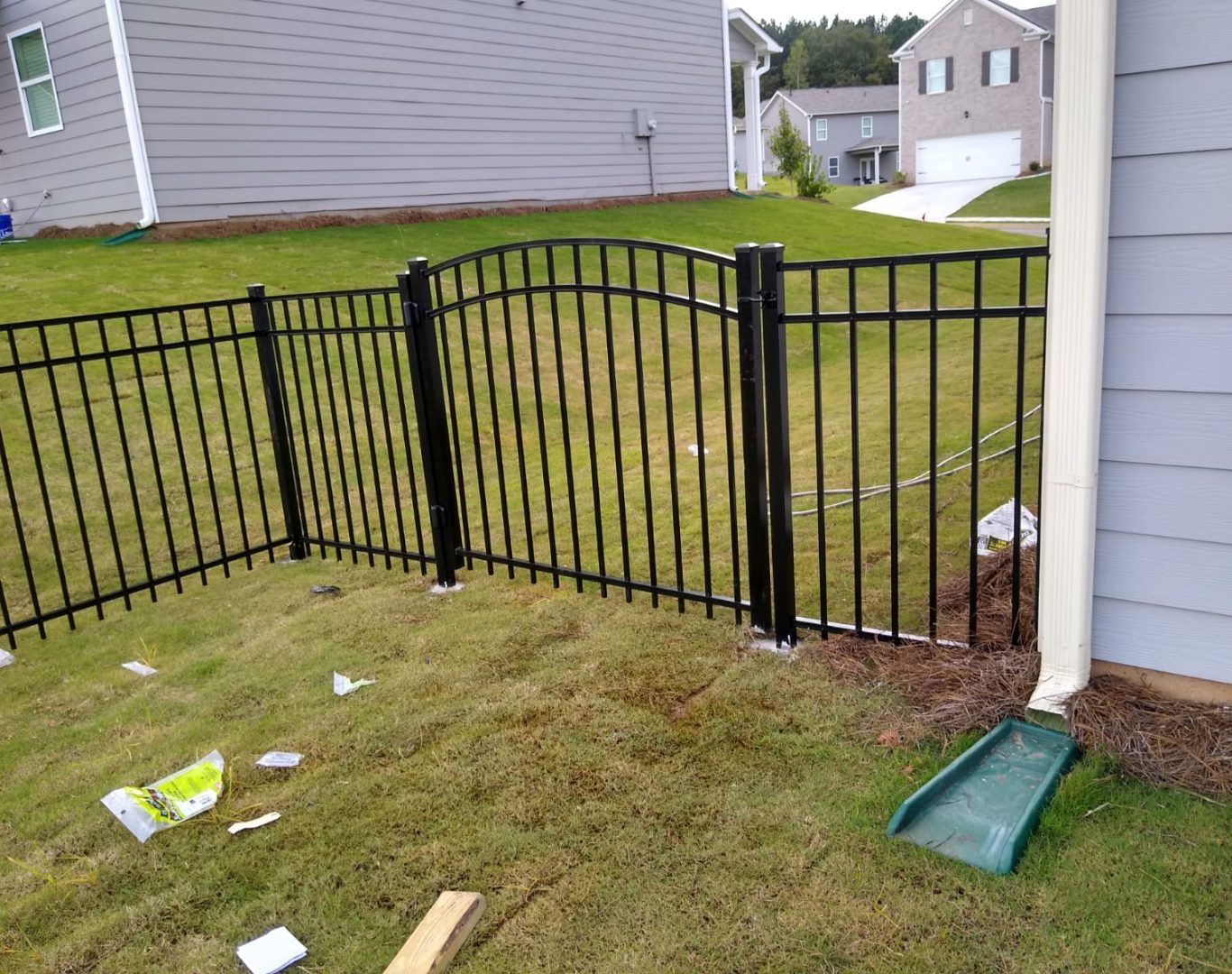 Decorative aluminum fence surrounding a front yard